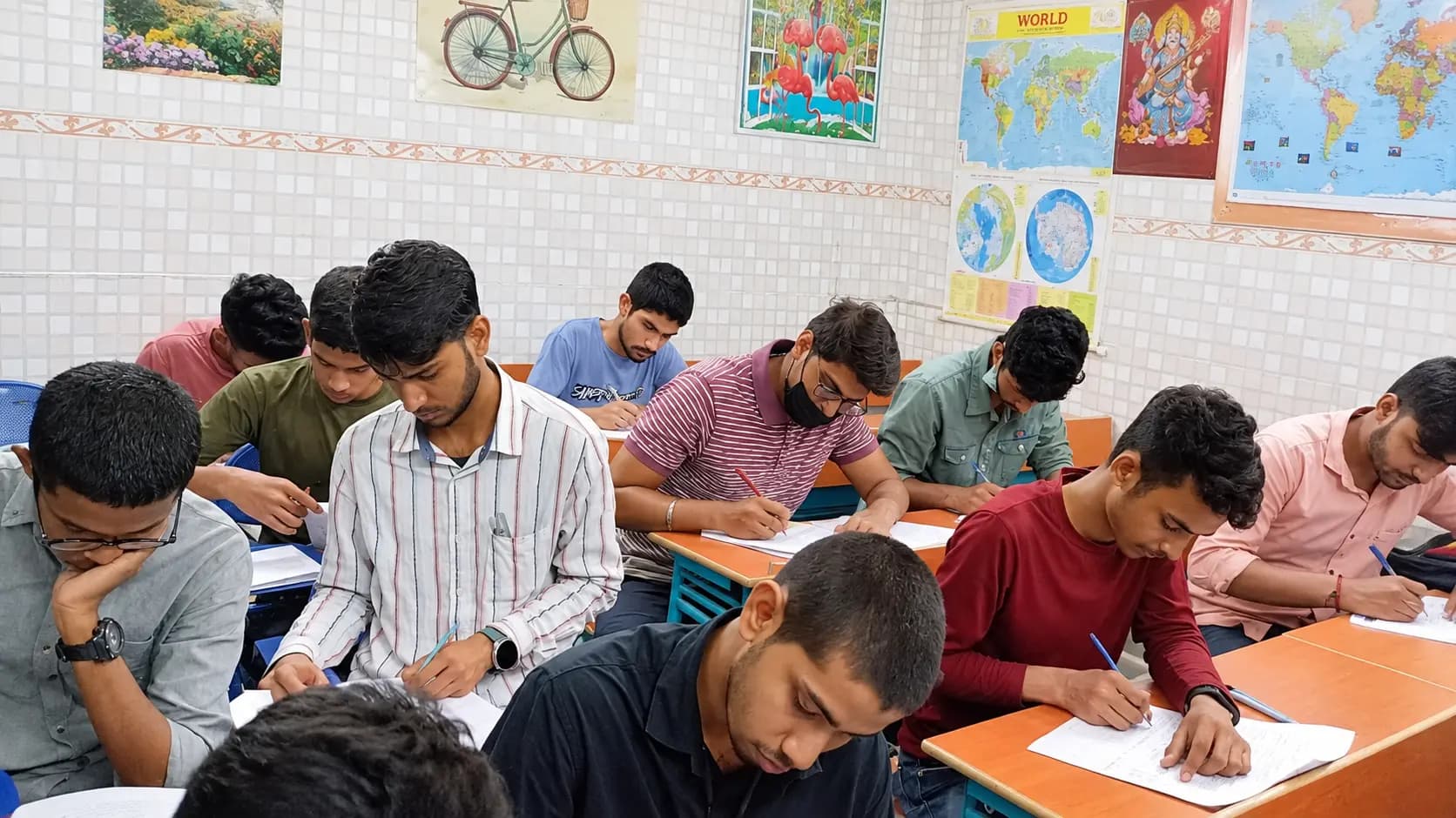 Students writing at their desks in a classroom